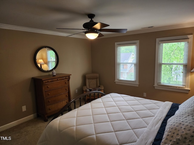 bedroom with carpet flooring, baseboards, crown molding, and a ceiling fan