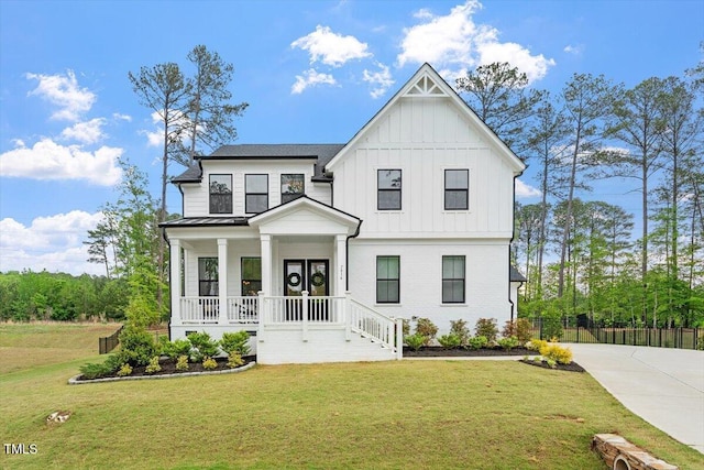7616 Hasentree Way, Wake Forest, NC 27587 - modern inspired farmhouse with covered porch, board and batten siding, a front yard, fence, and stairs