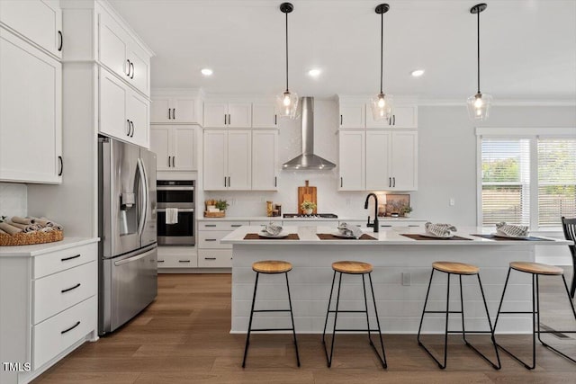 7616 Hasentree Way, Wake Forest, NC 27587 - kitchen featuring wall chimney range hood, a breakfast bar area, backsplash, crown molding, and appliances with stainless steel finishes