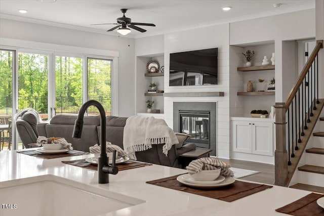 7616 Hasentree Way, Wake Forest, NC 27587 - living room featuring ceiling fan, built in shelves, stairway, and a fireplace