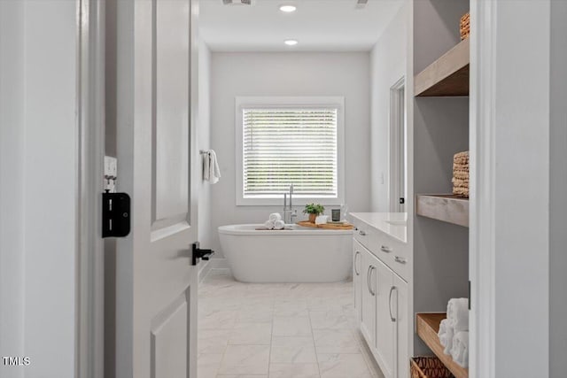 7616 Hasentree Way, Wake Forest, NC 27587 - bathroom featuring a freestanding tub, marble finish floor, and vanity