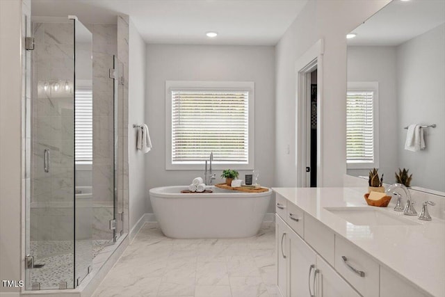 7616 Hasentree Way, Wake Forest, NC 27587 - full bath featuring a freestanding tub, a stall shower, vanity, marble finish floor, and recessed lighting