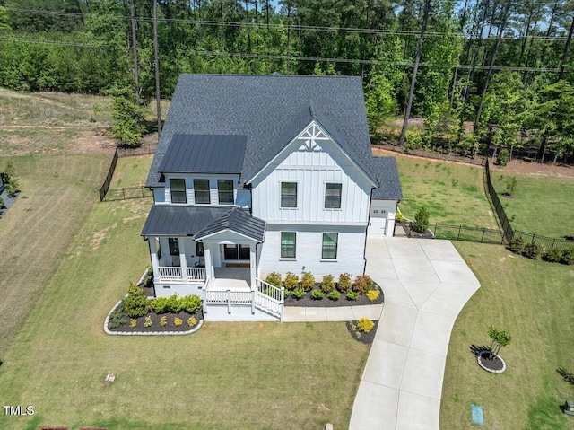 7616 Hasentree Way, Wake Forest, NC 27587 - view of front of home featuring fence, a front yard, board and batten siding, concrete driveway, and a porch