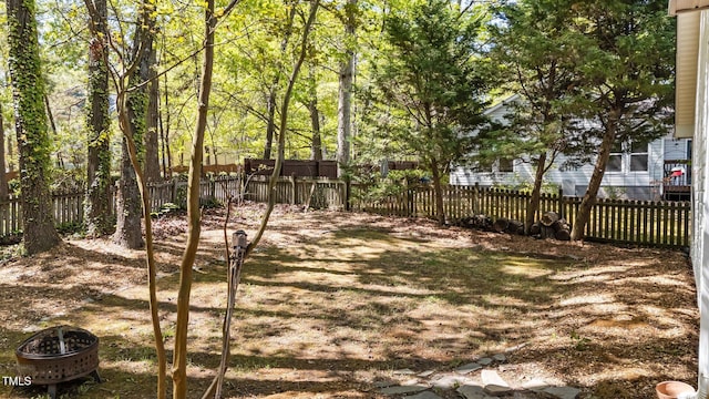 2941 Golden Oak Ct, Raleigh, NC 27603 - view of yard featuring a fenced backyard and a fire pit