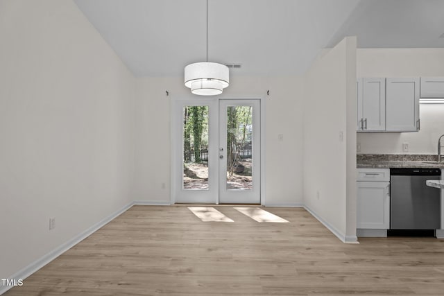 2941 Golden Oak Ct, Raleigh, NC 27603 - unfurnished dining area with light wood-style floors, visible vents, lofted ceiling, french doors, and baseboards