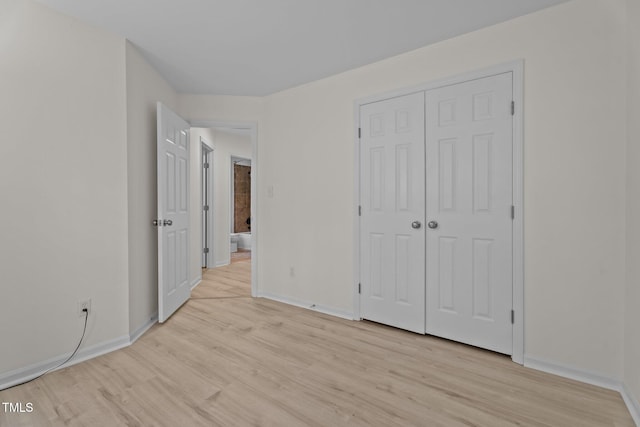 2941 Golden Oak Ct, Raleigh, NC 27603 - unfurnished bedroom featuring light wood-type flooring, a closet, and baseboards