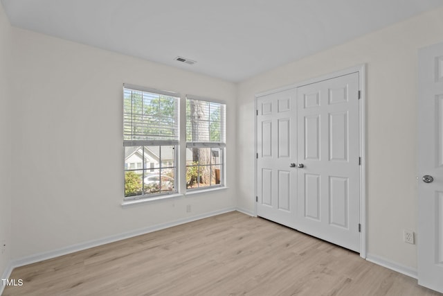 2941 Golden Oak Ct, Raleigh, NC 27603 - unfurnished bedroom featuring visible vents, multiple windows, baseboards, and light wood-style flooring