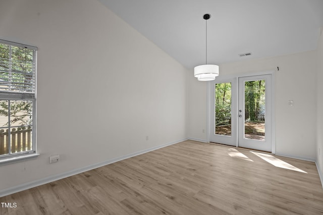 2941 Golden Oak Ct, Raleigh, NC 27603 - unfurnished dining area with visible vents, baseboards, vaulted ceiling, and wood finished floors