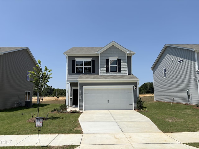 168 Bruce Dr, Dunn, NC 28334 - view of front facade with a front yard, driveway, and an attached garage