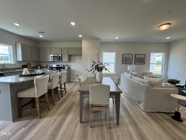 168 Bruce Dr, Dunn, NC 28334 - dining space with healthy amount of natural light, light wood finished floors, and recessed lighting