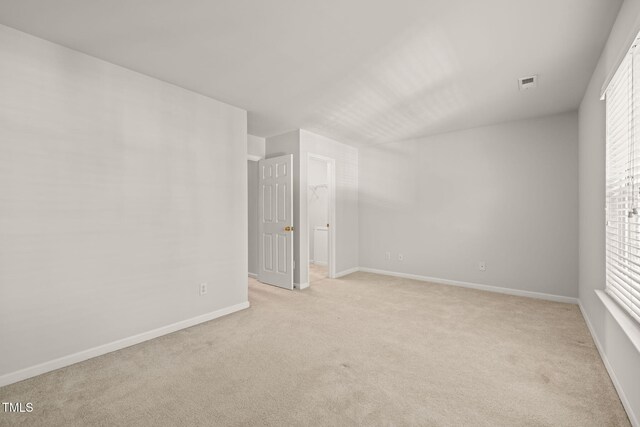 1116 Silky Dogwood Trl, Apex, NC 27502 - spare room featuring baseboards, visible vents, and light carpet