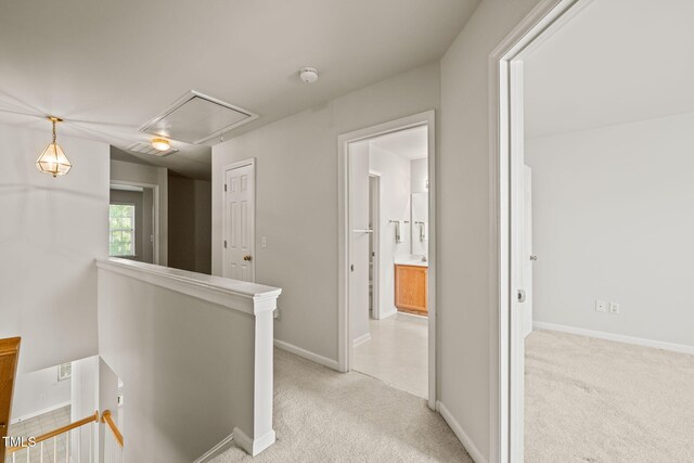 1116 Silky Dogwood Trl, Apex, NC 27502 - hall with light colored carpet, attic access, baseboards, and an upstairs landing