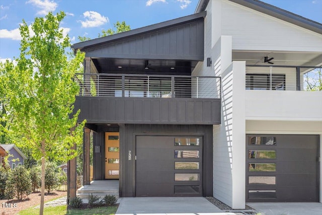 contemporary house with board and batten siding, concrete driveway, a balcony, and a garage