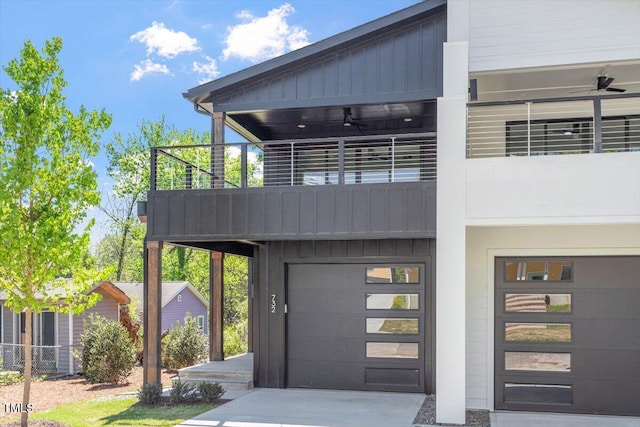 exterior space with an attached garage, board and batten siding, a balcony, and concrete driveway