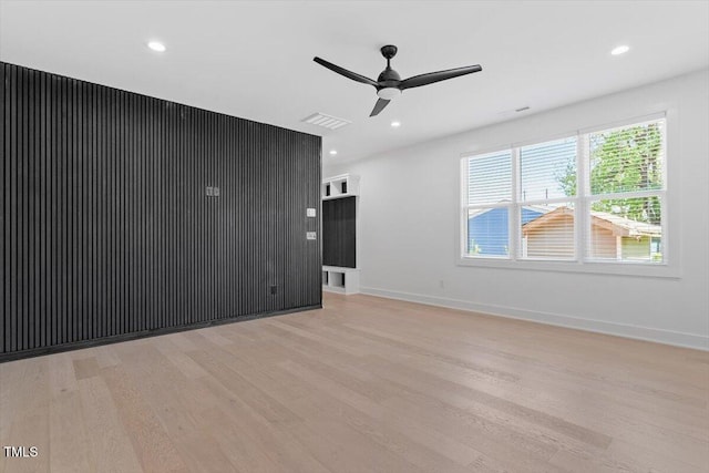 unfurnished living room featuring visible vents, a ceiling fan, light wood finished floors, and baseboards