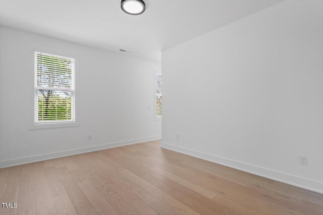 empty room featuring light wood-style floors and baseboards