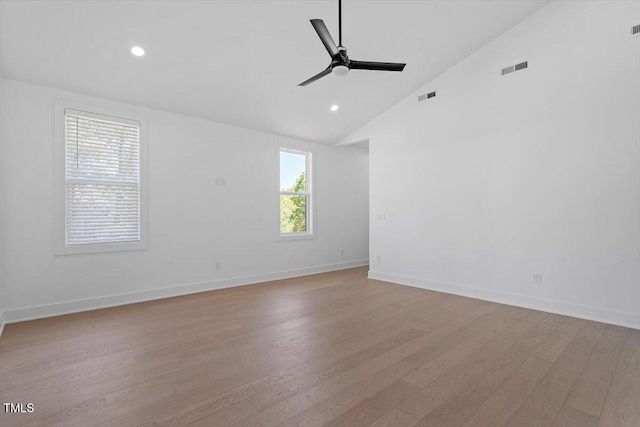 empty room featuring visible vents, a ceiling fan, light wood-style floors, and baseboards