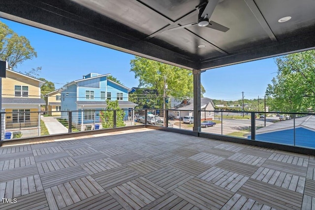 view of patio with a ceiling fan and a balcony