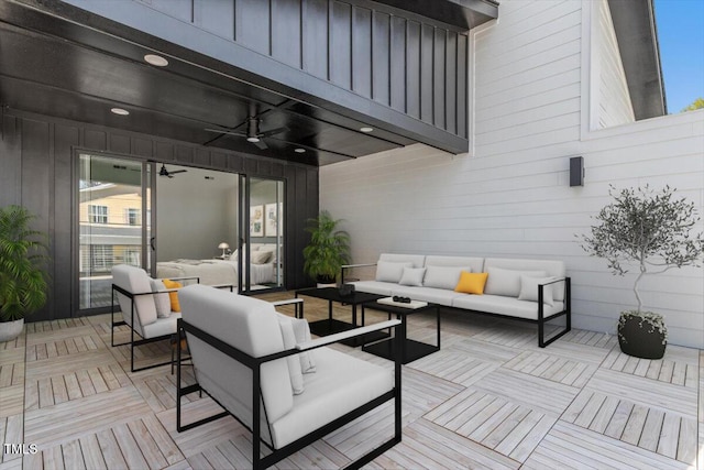 view of patio / terrace featuring a ceiling fan, a wooden deck, and an outdoor living space