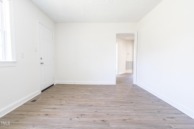 162 Valley Rd, Warrenton, NC 27589 - empty room with baseboards, a textured ceiling, visible vents, and wood finished floors