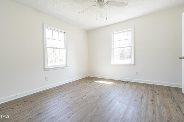 162 Valley Rd, Warrenton, NC 27589 - unfurnished room with baseboards, a textured ceiling, and wood finished floors