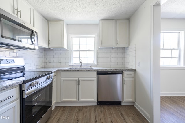 162 Valley Rd, Warrenton, NC 27589 - kitchen with a sink, appliances with stainless steel finishes, a wealth of natural light, and dark wood-type flooring