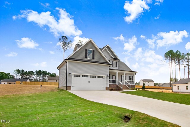 186 Gumtop Dr, Zebulon, NC 27597 - craftsman house featuring covered porch, concrete driveway, and a garage