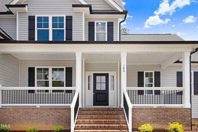 186 Gumtop Dr, Zebulon, NC 27597 - view of front facade with a shingled roof and covered porch