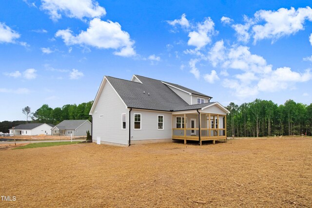 186 Gumtop Dr, Zebulon, NC 27597 - rear view of property with a shingled roof and a wooden deck