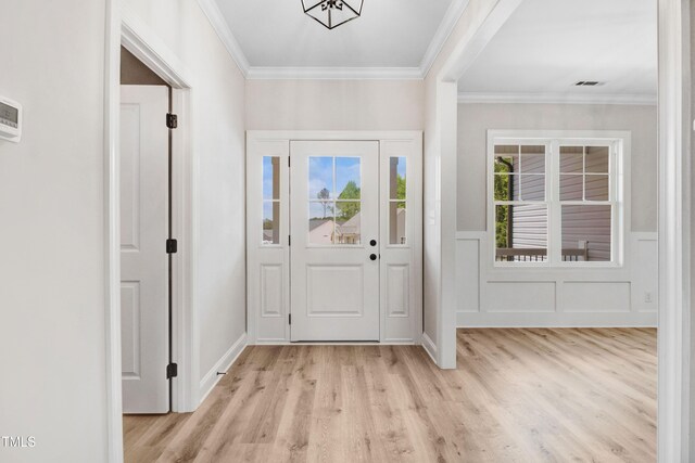 186 Gumtop Dr, Zebulon, NC 27597 - entrance foyer with light wood-type flooring, crown molding, and wainscoting
