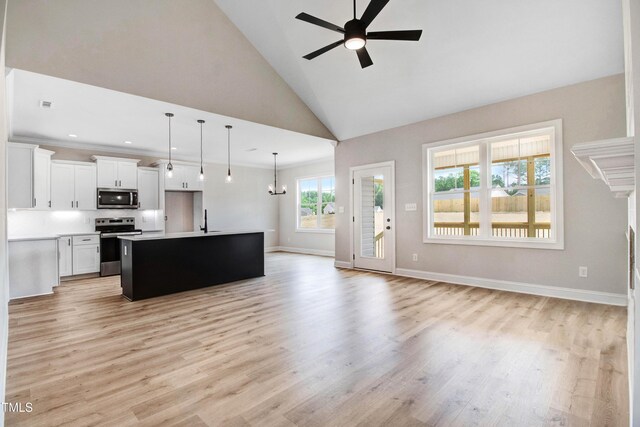 186 Gumtop Dr, Zebulon, NC 27597 - unfurnished living room featuring a ceiling fan, a sink, baseboards, light wood-style flooring, and high vaulted ceiling