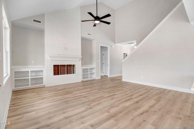 186 Gumtop Dr, Zebulon, NC 27597 - unfurnished living room featuring wood finished floors, high vaulted ceiling, a fireplace, ceiling fan, and baseboards