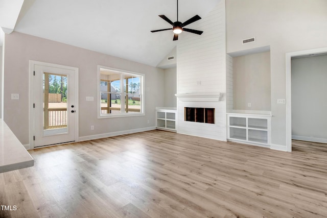 186 Gumtop Dr, Zebulon, NC 27597 - unfurnished living room featuring wood finished floors, baseboards, a ceiling fan, high vaulted ceiling, and a fireplace