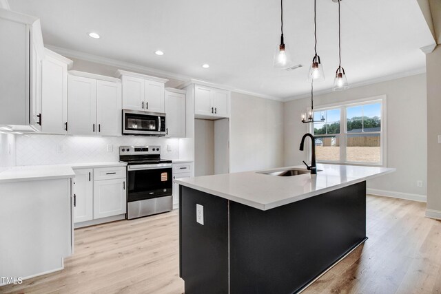 186 Gumtop Dr, Zebulon, NC 27597 - kitchen with appliances with stainless steel finishes, a sink, ornamental molding, light wood-style floors, and backsplash