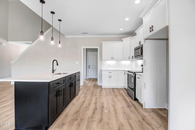 186 Gumtop Dr, Zebulon, NC 27597 - kitchen with a sink, stainless steel appliances, white cabinets, ornamental molding, and recessed lighting