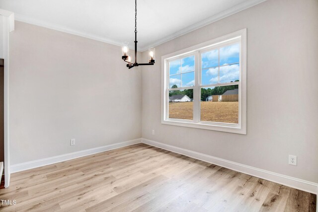 186 Gumtop Dr, Zebulon, NC 27597 - empty room featuring light wood-type flooring, crown molding, a chandelier, and baseboards