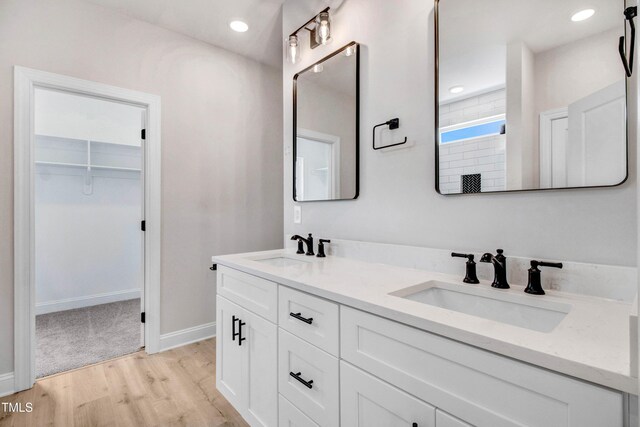 186 Gumtop Dr, Zebulon, NC 27597 - full bath featuring double vanity, wood finished floors, a spacious closet, a tile shower, and baseboards