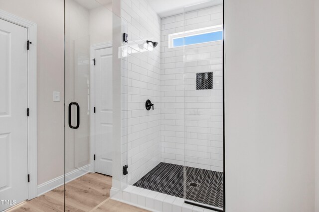 186 Gumtop Dr, Zebulon, NC 27597 - bathroom with a shower stall, wood finished floors, and baseboards