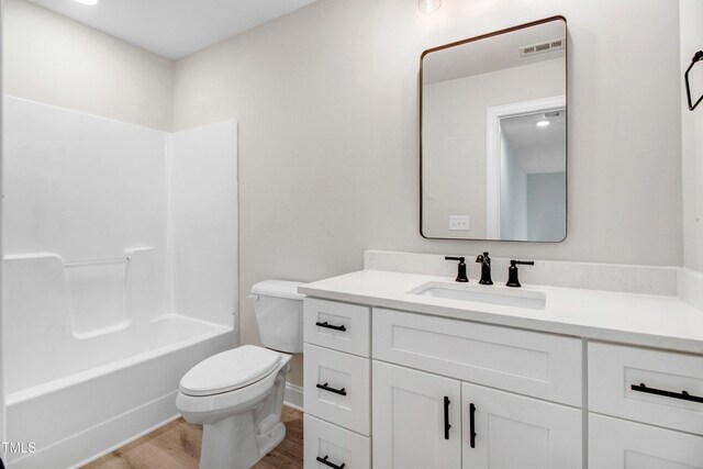 186 Gumtop Dr, Zebulon, NC 27597 - full bathroom featuring toilet, vanity, wood finished floors, shower / washtub combination, and baseboards