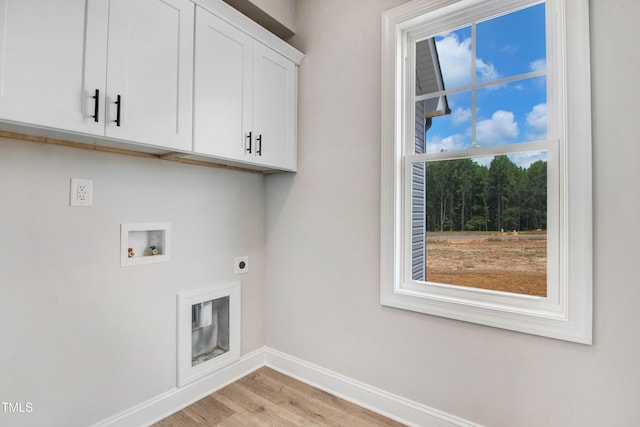 186 Gumtop Dr, Zebulon, NC 27597 - washroom featuring hookup for an electric dryer, baseboards, cabinet space, washer hookup, and light wood-type flooring