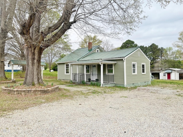 bungalow featuring a porch, crawl space, and metal roof