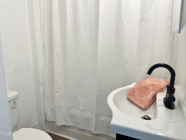 bathroom featuring toilet and a sink