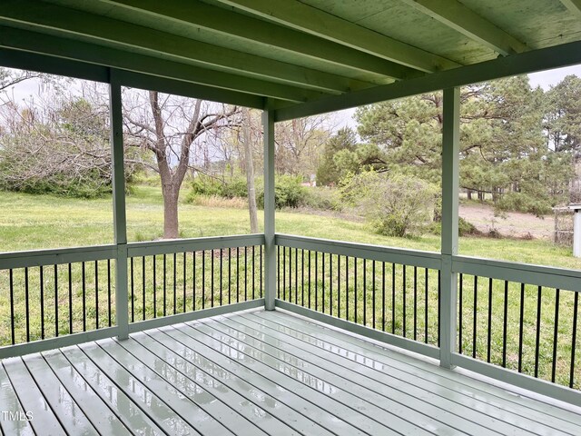 wooden terrace with a lawn