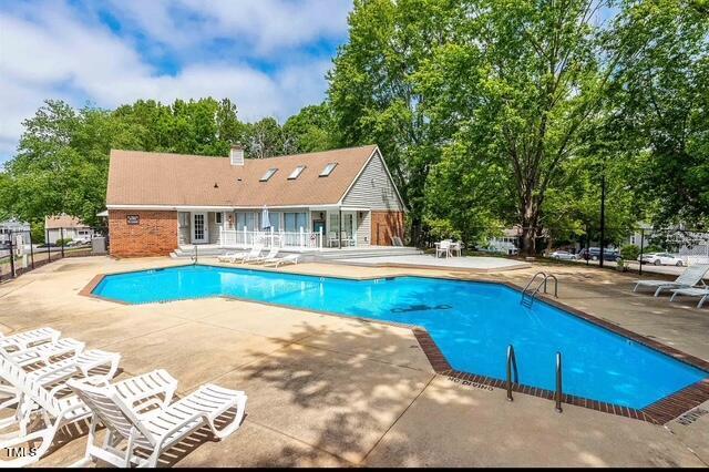 pool with fence and a patio