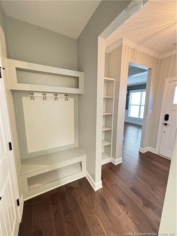 mudroom featuring baseboards, crown molding, and wood finished floors