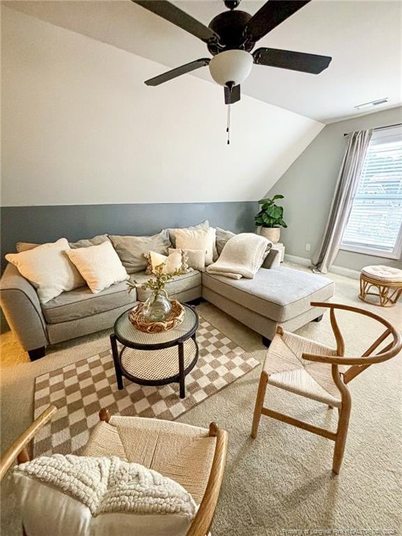 carpeted living room featuring ceiling fan, vaulted ceiling, and visible vents