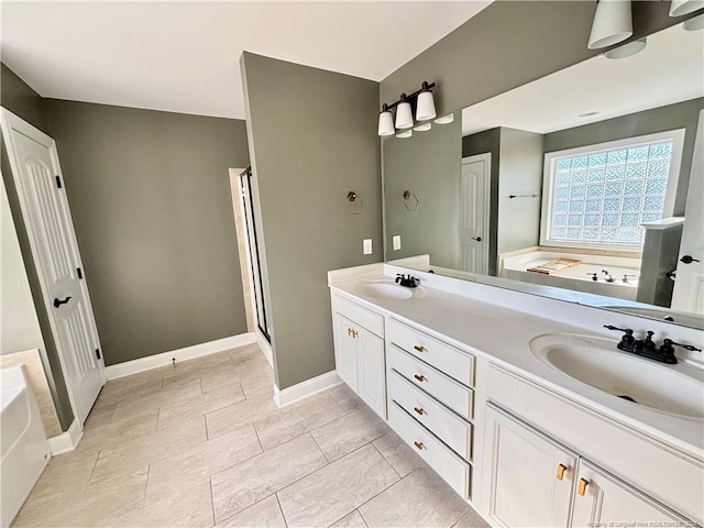 bathroom featuring double vanity, a sink, a stall shower, and a bath