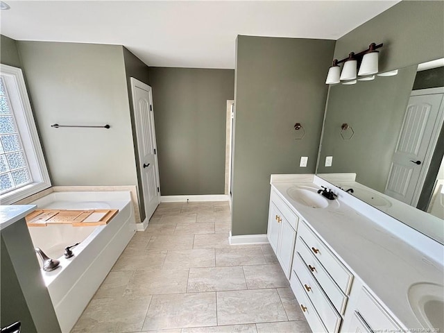 full bath with double vanity, a bath, baseboards, and a sink