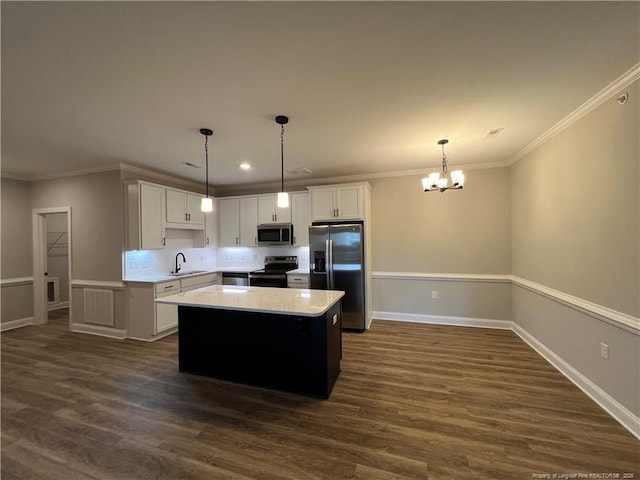 kitchen featuring light countertops, white cabinets, appliances with stainless steel finishes, and a chandelier