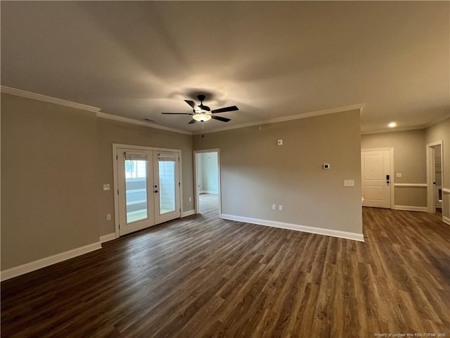 empty room with dark wood finished floors, baseboards, crown molding, and a ceiling fan